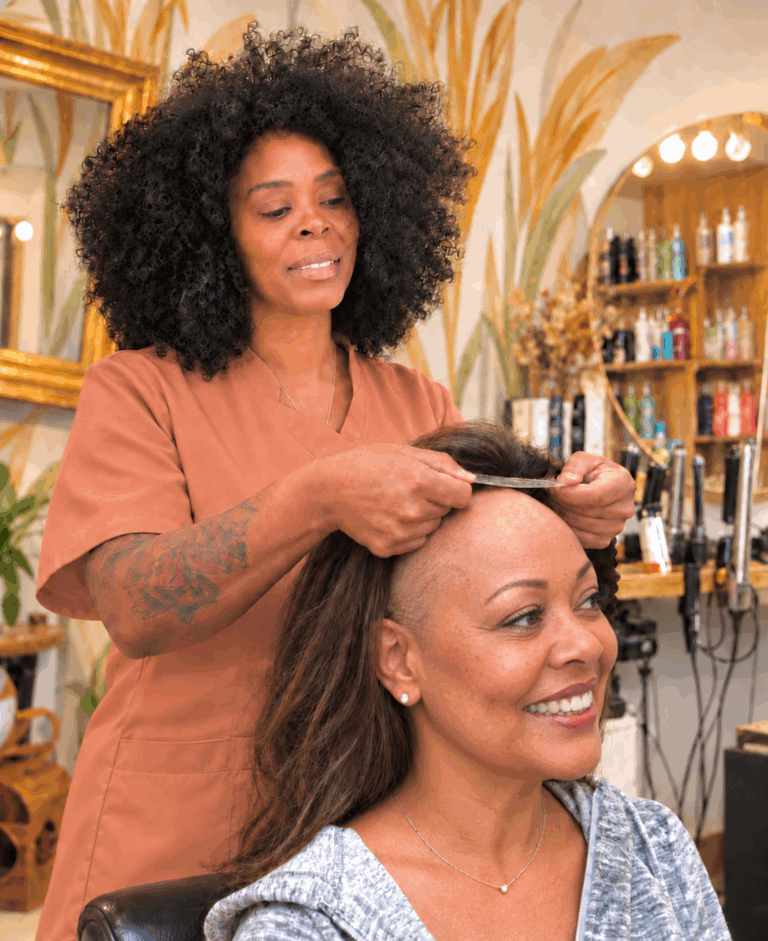 Illustration of Lorraine fitting a bespoke wig on a client with hair loss in the Salonlareine salon in Bristol.